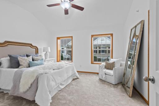 Upstairs, you'll find three bedrooms, all featuring brand-new carpeting, including a spacious primary suite with 10-foot vaulted ceilings, a ceiling fan, and a large front-facing window.