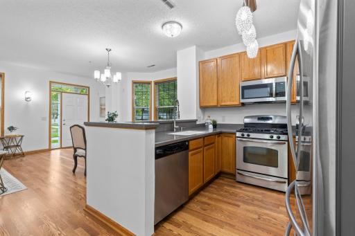 An alternate view of the kitchen with views of the nearby dining room.