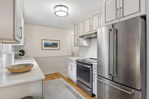 Remodeled kitchen with new cabinetry and stainless-steel appliances.