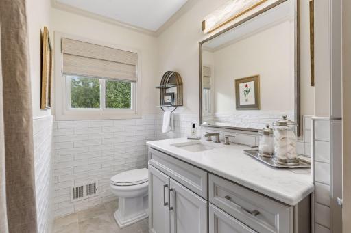 Updated vanity, flooring and Anderson window complete the remodeled main-level bathroom.