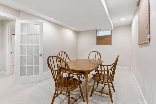 Lower-level flex room with glass French doors offers an ideal space for a home office or hobby room.