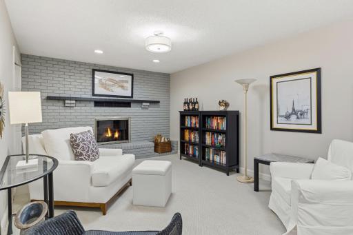 Wood-burning fireplace with painted brick surround.