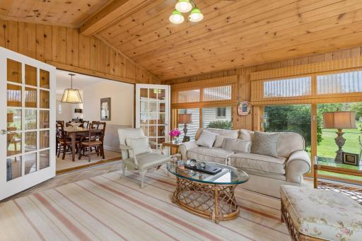 French doors connect the dining area to the spacious three-season porch.