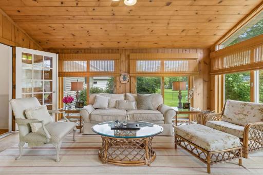 Six newer Andersen sliding glass doors fill with porch with natural light.