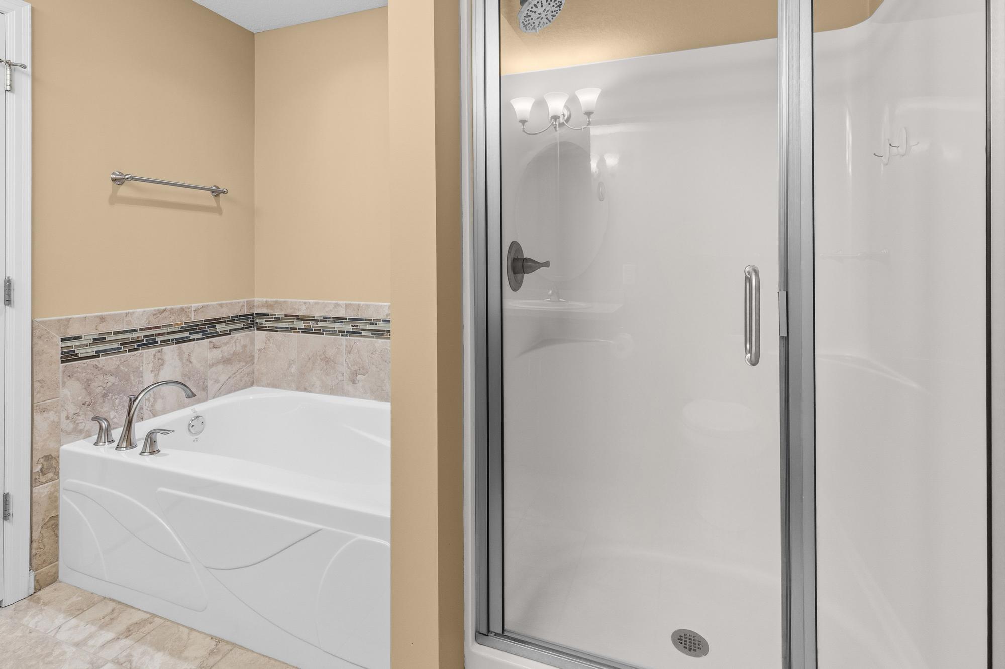 Separate soaking tub and step in shower