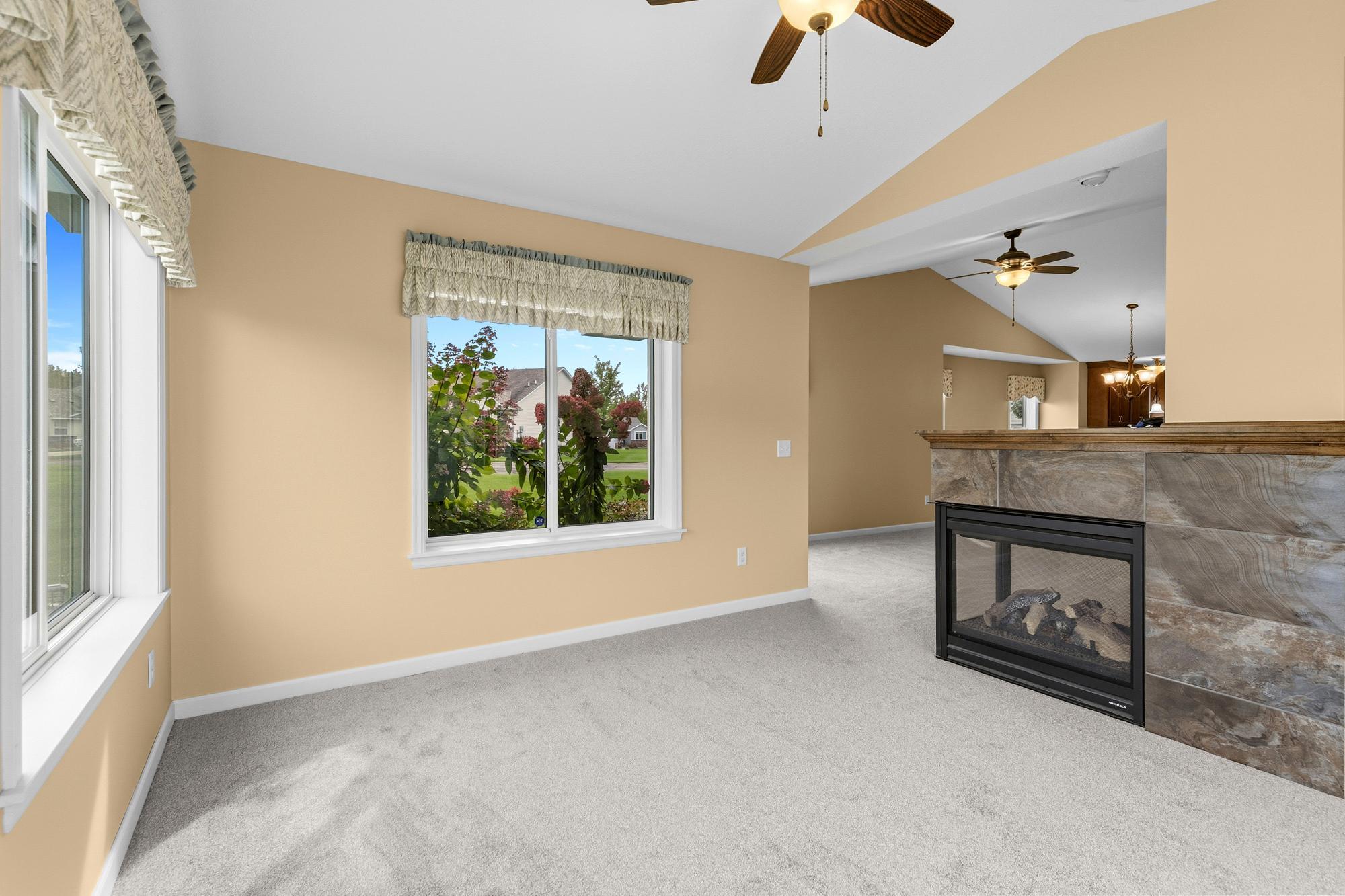 Sunroom is surrounded by blooming perennials
