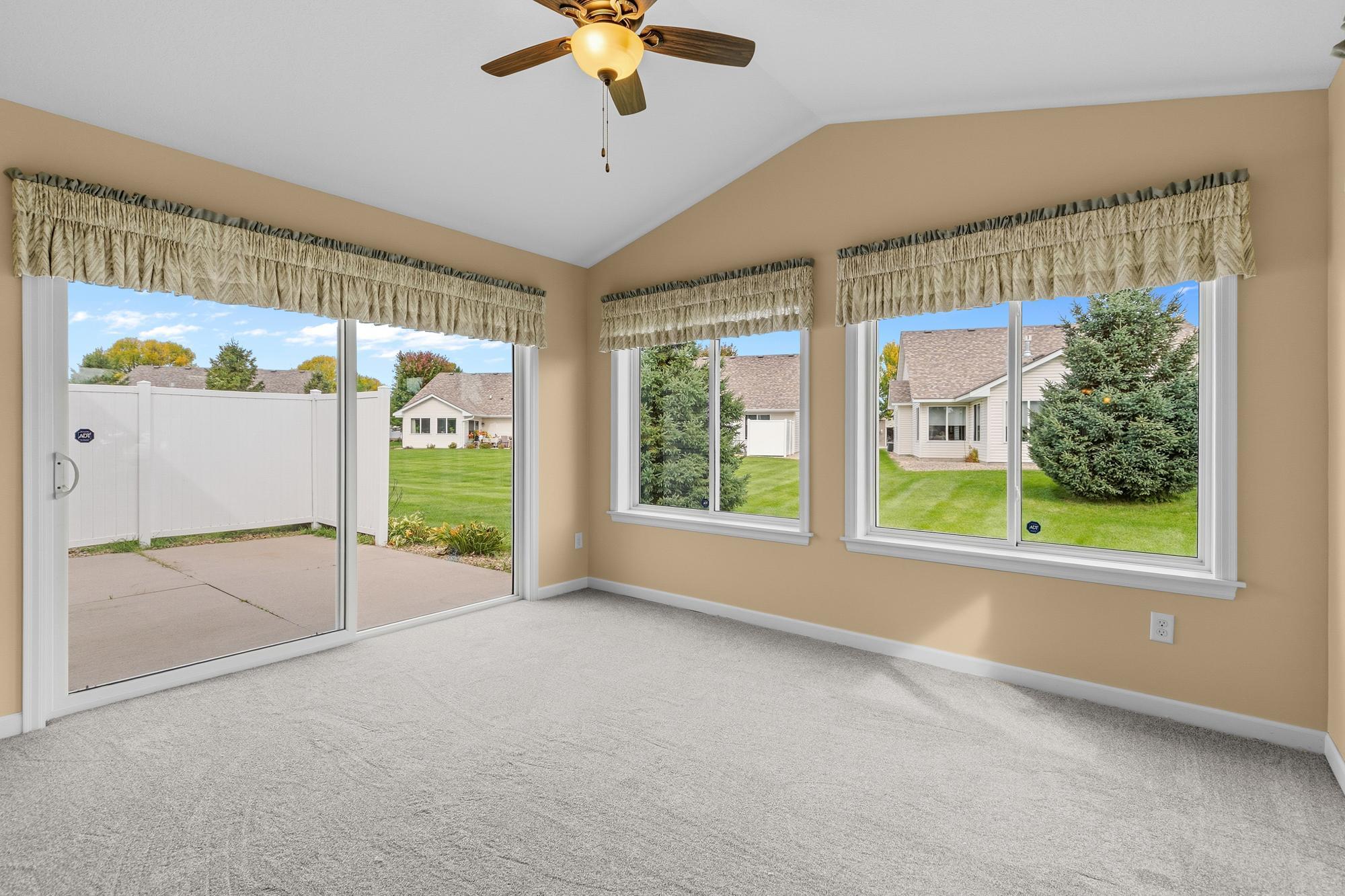 The sunroom sliding glass door leads to the private patio