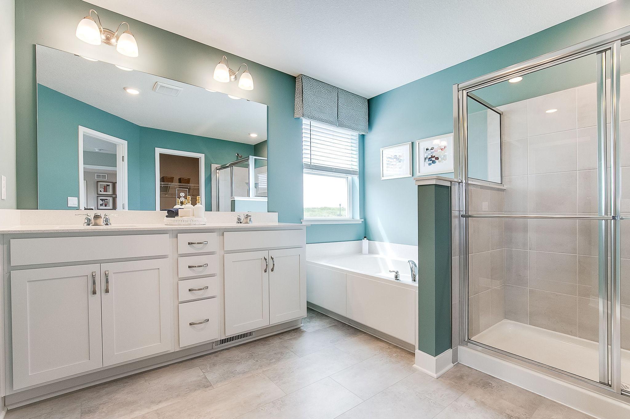 Primary ensuite bathroom is an oasis of its own. Two walk-in closets, double bowl, executive height vanity and separate tub/shower. *Picture is of model home; actual finishes may vary.