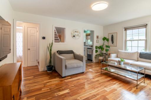 To the left of frame is the hallway which leads to two main floor bedrooms and the full bath. Neutral colors and abundant natural lighting make this home ready for your personal touches.
