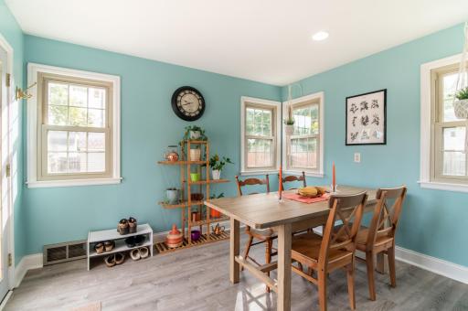 A large patio door and windows on every wall of the dining area add beautiful natural light and views of the backyard.