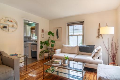 Warm finishes like the hardwood flooring, and large windows make this a comfortable space to relax, watch a movie or curl up with a book.