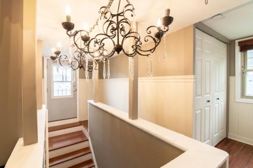 The door at the top of the stairs leads to a flat roof. While not currently in use as a balcony, you could add a railing to make additional outdoor seating space.