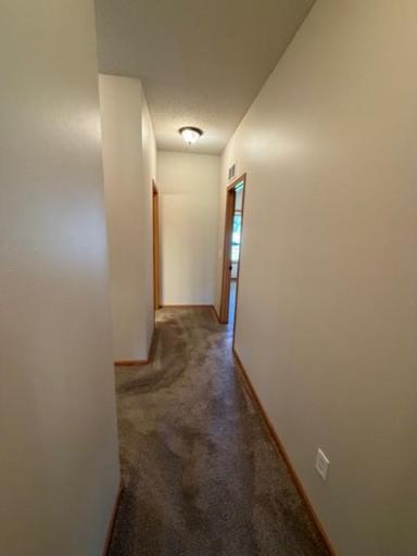 44 hallway from primary to main bath on left and second bedroom on right.jpg