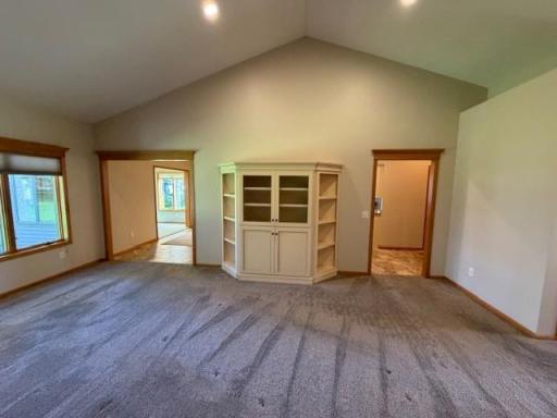 12.5 living room with dining and sun on left kitchen and laundry on right side.jpg