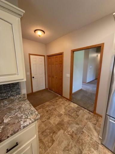 25 kitchen garage service living room entry perspective.jpg