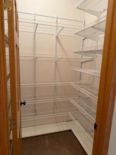 28 large hall closet with 3 walls of shelving.jpg