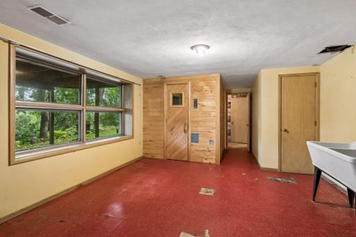 Laundry and versatile flex space with access to sauna.