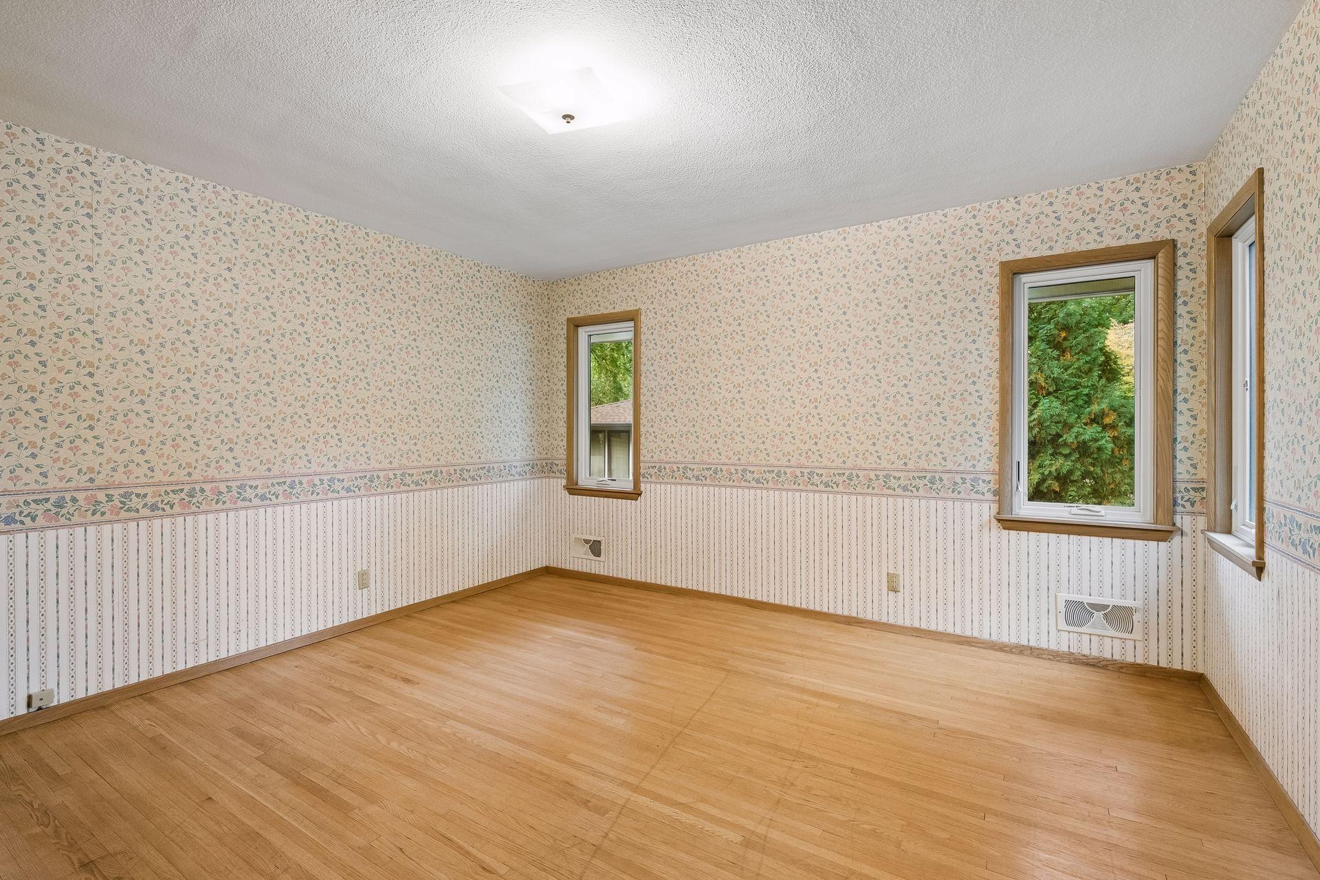 Second bedroom with classic hardwood floors.