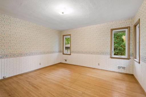 Second bedroom with classic hardwood floors.