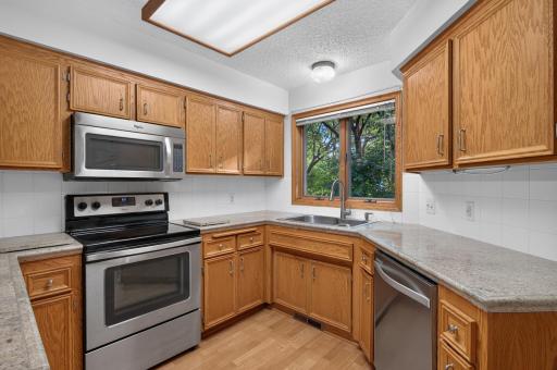 Well cared for. Thoughtfully refreshed. Ready for you. Stainless steel appliances. Beautiful countertops. Exceptional natural woodwork. Window with beautiful view of natural surroundings.