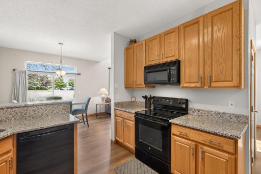 Super spacious Kitchen with sit up raised peninsula, granite countertops and tons of storage/prep space!