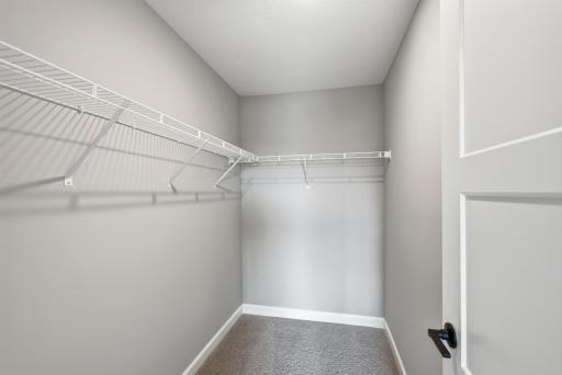 Primary suite walk-in closet - photos of a completed home of the same floorplan. Colors and selections may differ.
