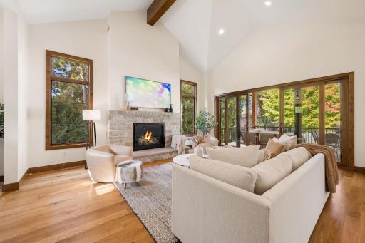 Great room with beams that overlooks the backyard