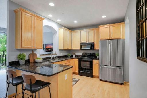 Virtually staged kitchen. Enjoy a casual meal at the countertop.