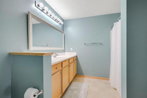 Large full bathroom with linen closet.