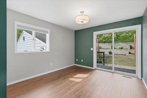Main floor bedroom with access to private rear yard and ground-level deck.