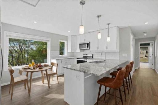 Virtually staged - The kitchen can accommodate a small table for morning coffee and extended seating at the breakfast bar.