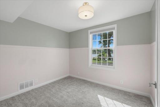 Third bedroom with new carpet and light fixture.