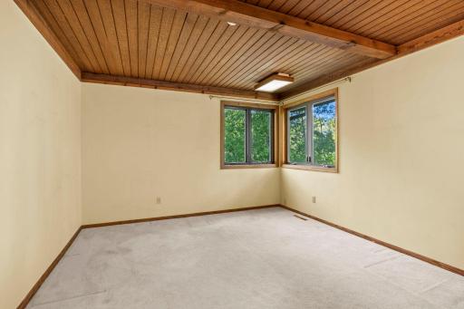 Corner windows and dramatic wood paneled ceilings.