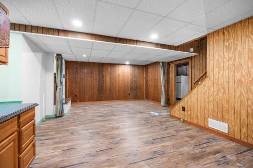 The finished lower level offers flexible bonus space with durable flooring, warm wood accents, and a convenient wet bar with abundant cabinetry and counter space. Ideal for entertaining, a game room, or casual gathering space.