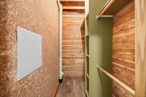 Walk in cedar closet with organization shelving.
