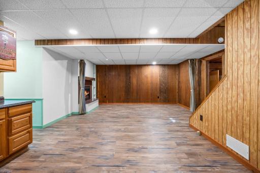 The finished lower level offers flexible bonus space with durable flooring, warm wood accents, and a convenient wet bar with abundant cabinetry and counter space. Ideal for entertaining, a game room, or casual gathering spa3rd wood burning fireplace!