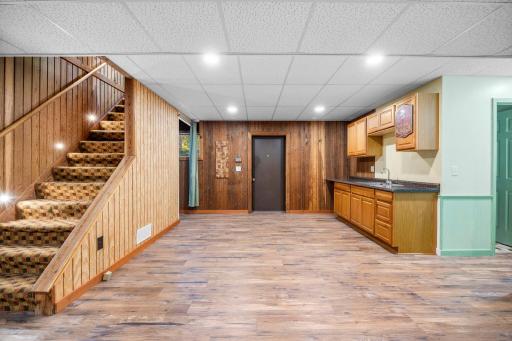 The finished lower level offers flexible bonus space with durable flooring, warm wood accents, and a convenient wet bar with abundant cabinetry and counter space. Ideal for entertaining, a game room, or casual gathering space.