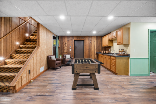 Recreation room offers so much opportunity. Game area, wet bar. Setup perfect for entertaining. Beautiful warm wood paneling and LVP flooring.