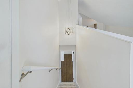 View from top of the stairs looking down to the dining room.