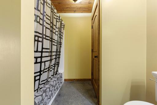 The full lower level bathroom includes a tub/ shower combo.