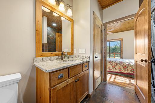 The ensuite also features a granite vanity top and tile floors. Storage is abundant in the linen closet.