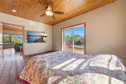 Another view of the primary bedroom. A sliding patio door leads out to the expansive deck.