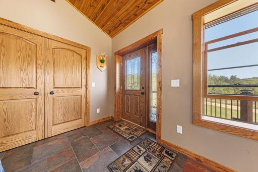 Step into the spacious foyer featuring a coat closet.