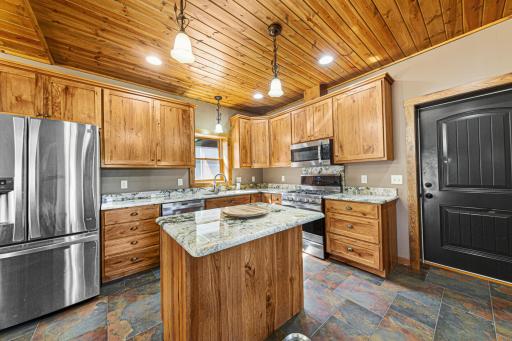 Rich wood cabinets and granite countertops provide a feel of luxury in this kitchen.