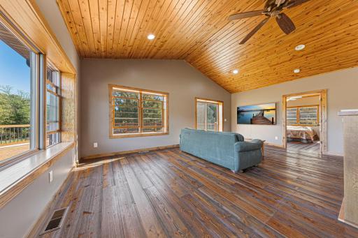 The living room features vaulted ceilings and recessed canister lighting.