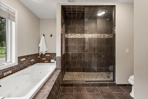 Expansive tiled walk-in shower for true spa-like experience.