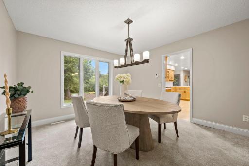 The formal dining room adds its own personality with carpeting and statement lighting.