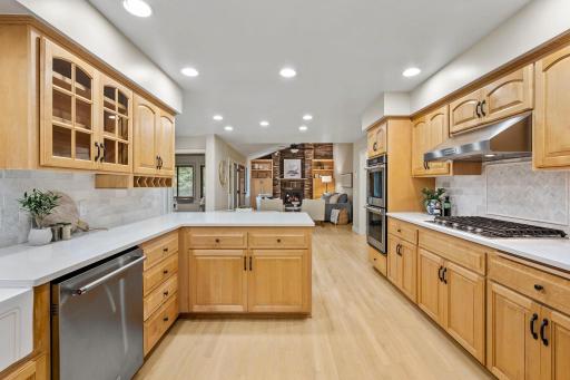 Enjoy pull-out shelving, a walk-in pantry, and a peninsula with counter seating.