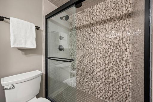 Large walk-in shower that brings a spa-like feel to the space. Even the utility room has purpose, with a double utility sink, workbench, and shelving ready for projects, hobbies, storage, or whatever else you need to tackle.