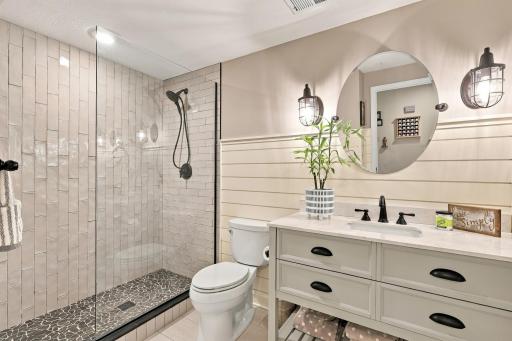 Shiplap details, custom cabinetry & pebble stone shower floor